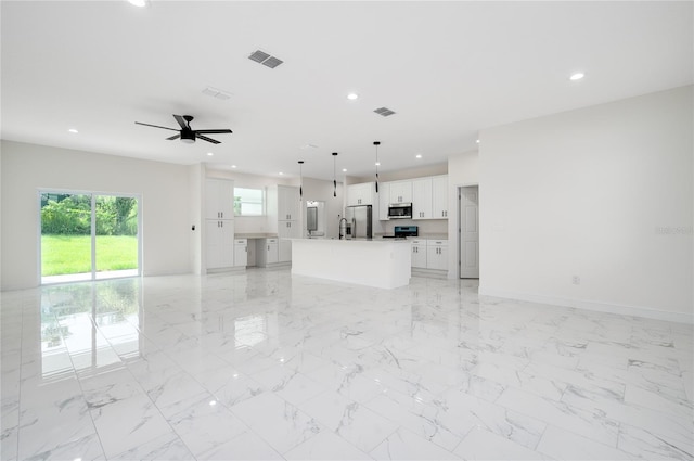 1157 W Hancock Dr, Deltona, FL 32725 - unfurnished living room featuring ceiling fan, recessed lighting, and light marble finish floors