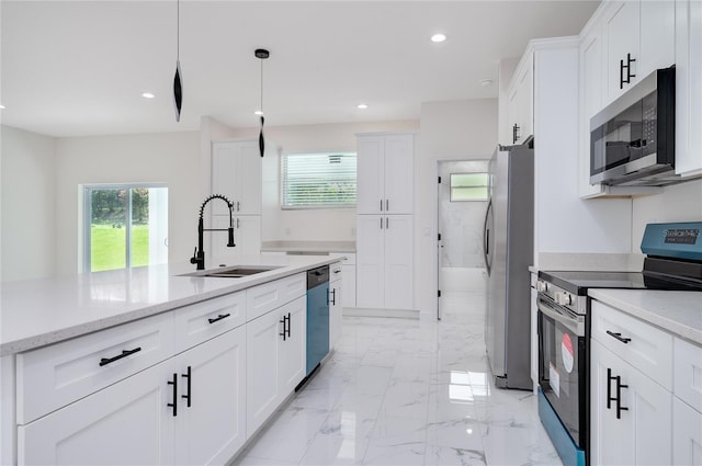 1157 W Hancock Dr, Deltona, FL 32725 - kitchen with appliances with stainless steel finishes, white cabinets, plenty of natural light, and recessed lighting
