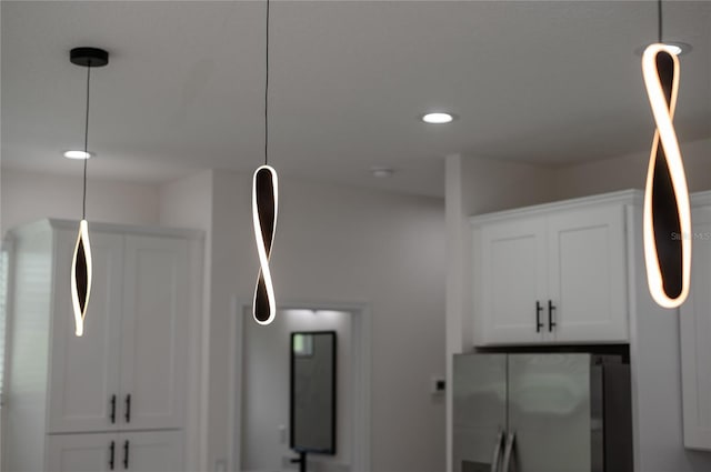 1157 W Hancock Dr, Deltona, FL 32725 - kitchen view of freestanding refrigerator, white cabinetry, pendant lighting, recessed lighting, and fridge