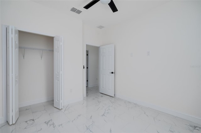 1157 W Hancock Dr, Deltona, FL 32725 - unfurnished bedroom featuring marble look tiles, a closet, and a ceiling fan
