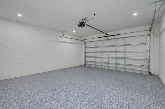 1157 W Hancock Dr, Deltona, FL 32725 - garage with a garage door opener, concrete block wall, and recessed lighting