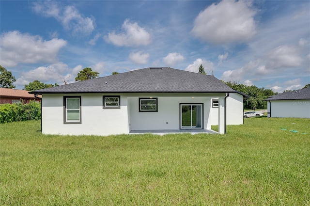 1157 W Hancock Dr, Deltona, FL 32725 - back of property featuring a lawn, stucco siding, and a shingled roof