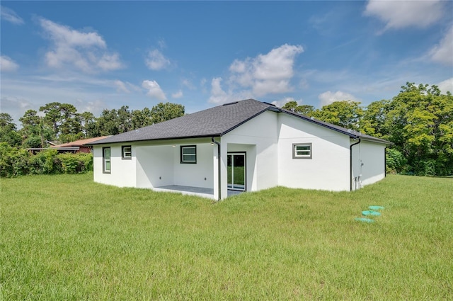 1157 W Hancock Dr, Deltona, FL 32725 - back of property with a lawn and stucco siding