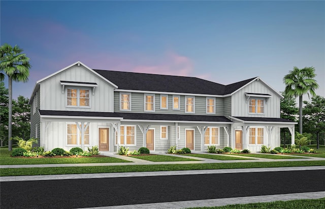 2302 Southbury Dr, Kissimmee, FL 34744 - modern inspired farmhouse with board and batten siding, a lawn, and roof with shingles
