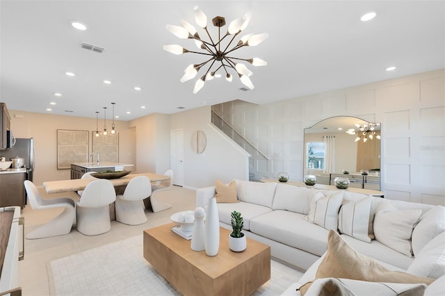 2302 Southbury Dr, Kissimmee, FL 34744 - living room featuring a chandelier, stairs, recessed lighting, light tile patterned floors, and arched walkways