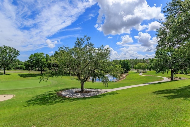 4216 Fawn Meadows Cir, Clermont, FL 34711 - view of community featuring view of golf course, a lawn, and view of wooded area