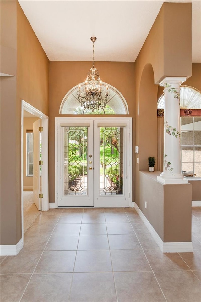 4216 Fawn Meadows Cir, Clermont, FL 34711 - entryway with tile patterned floors, french doors, a chandelier, and arched walkways
