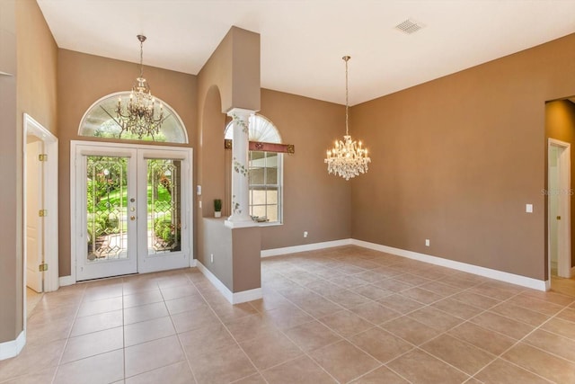 4216 Fawn Meadows Cir, Clermont, FL 34711 - foyer entrance with a chandelier, light tile patterned flooring, french doors, and arched walkways