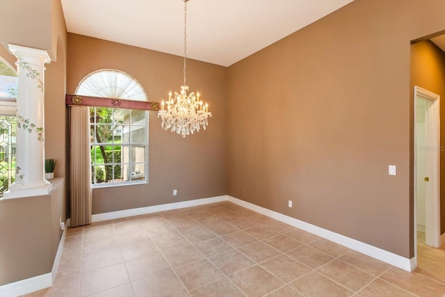 4216 Fawn Meadows Cir, Clermont, FL 34711 - spare room featuring light tile patterned floors, ornate columns, and a chandelier