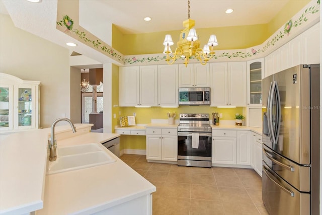 4216 Fawn Meadows Cir, Clermont, FL 34711 - kitchen with stainless steel appliances, a chandelier, light tile patterned floors, white cabinets, and recessed lighting