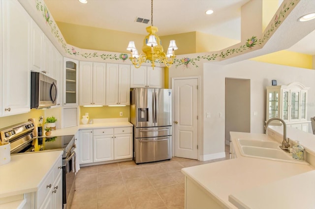 4216 Fawn Meadows Cir, Clermont, FL 34711 - kitchen featuring appliances with stainless steel finishes, a chandelier, light tile patterned floors, white cabinetry, and recessed lighting