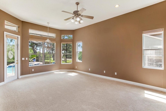 4216 Fawn Meadows Cir, Clermont, FL 34711 - empty room with light carpet, plenty of natural light, a chandelier, and recessed lighting