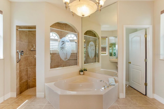 4216 Fawn Meadows Cir, Clermont, FL 34711 - bathroom featuring a bath, a tile shower, and tile patterned flooring