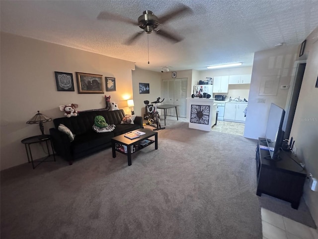320 Forestway Cir Unit 203, Altamonte Springs, FL 32701 - living room with ceiling fan, a textured ceiling, and light colored carpet