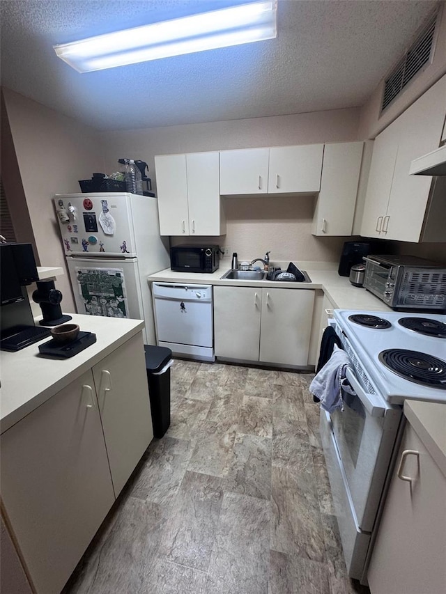 320 Forestway Cir Unit 203, Altamonte Springs, FL 32701 - kitchen with white appliances, light countertops, a textured ceiling, white cabinetry, and light stone finish flooring