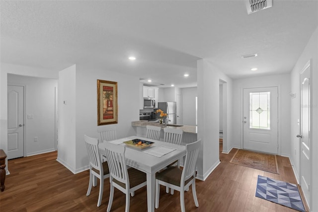 69 Pin Oak Dr, Palm Coast, FL 32164 - dining area featuring wood finished floors and recessed lighting