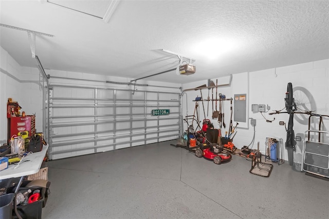69 Pin Oak Dr, Palm Coast, FL 32164 - garage with electric panel, concrete block wall, and a garage door opener