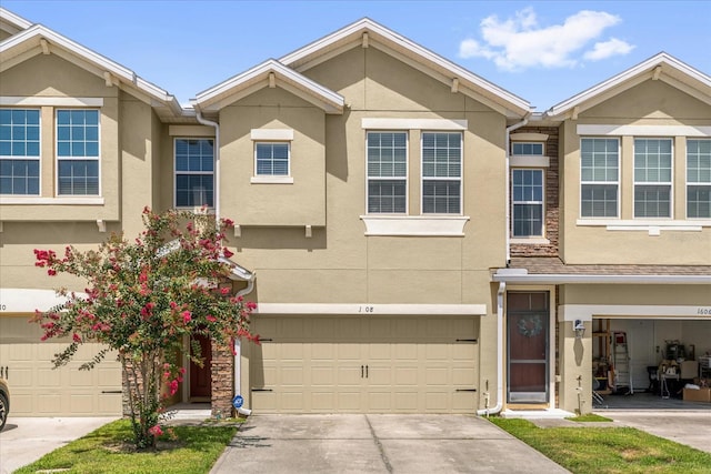 1608 Mohegan Blvd, Kissimmee, FL 34744 - traditional home featuring stucco siding, a garage, and driveway