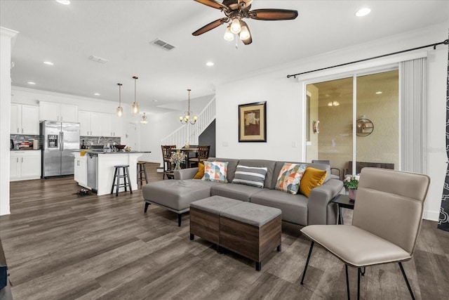 1608 Mohegan Blvd, Kissimmee, FL 34744 - living room with a ceiling fan, recessed lighting, ornamental molding, dark wood-style floors, and a chandelier