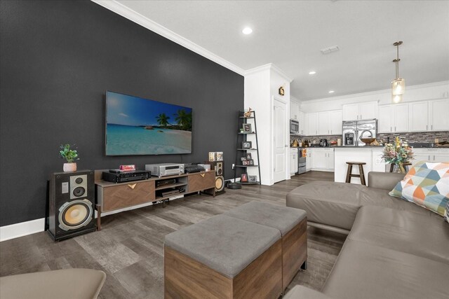 1608 Mohegan Blvd, Kissimmee, FL 34744 - living room featuring dark wood-type flooring, ornamental molding, and recessed lighting