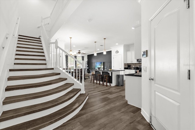 1608 Mohegan Blvd, Kissimmee, FL 34744 - stairway with wood finished floors, a ceiling fan, recessed lighting, and crown molding