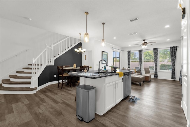 1608 Mohegan Blvd, Kissimmee, FL 34744 - kitchen featuring dark wood-type flooring, recessed lighting, stainless steel dishwasher, dark countertops, and white cabinets