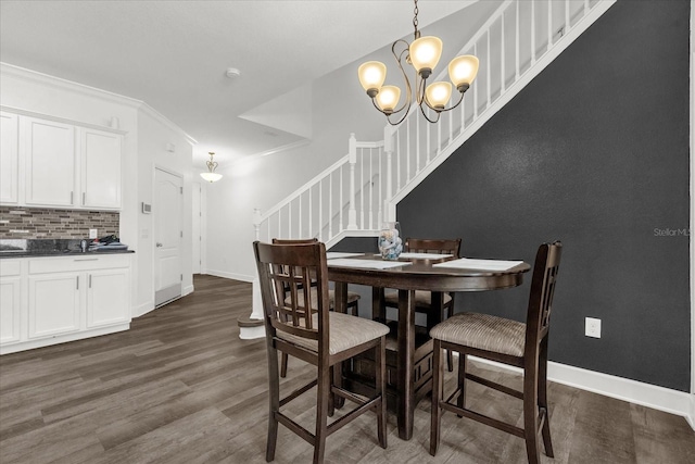 1608 Mohegan Blvd, Kissimmee, FL 34744 - dining room with stairway, dark wood-style flooring, a chandelier, and ornamental molding