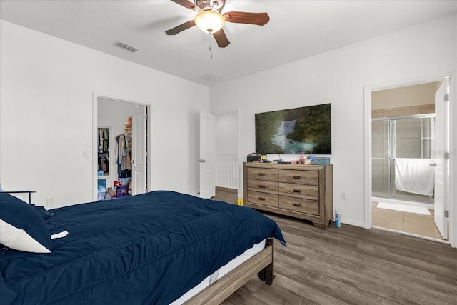 1608 Mohegan Blvd, Kissimmee, FL 34744 - bedroom featuring wood finished floors, a walk in closet, ensuite bath, and a ceiling fan