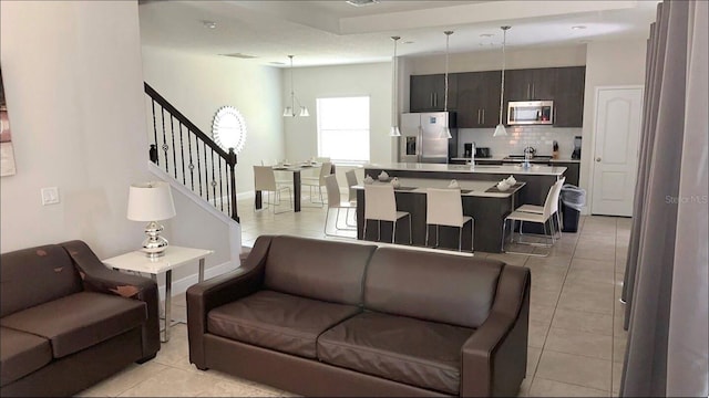 197 Macaulays Cv, Haines City, FL 33844 - living area featuring light tile patterned floors and stairway