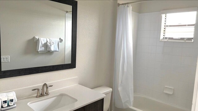 197 Macaulays Cv, Haines City, FL 33844 - bathroom with vanity, shower / tub combo with curtain, and a textured wall