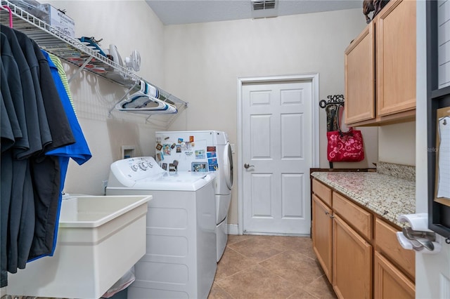 859 Leather Fern Ln, Mims, FL 32754 - washroom featuring washing machine and clothes dryer, light tile patterned flooring, and cabinet space