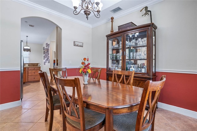 859 Leather Fern Ln, Mims, FL 32754 - dining space with light tile patterned flooring, arched walkways, crown molding, and a chandelier