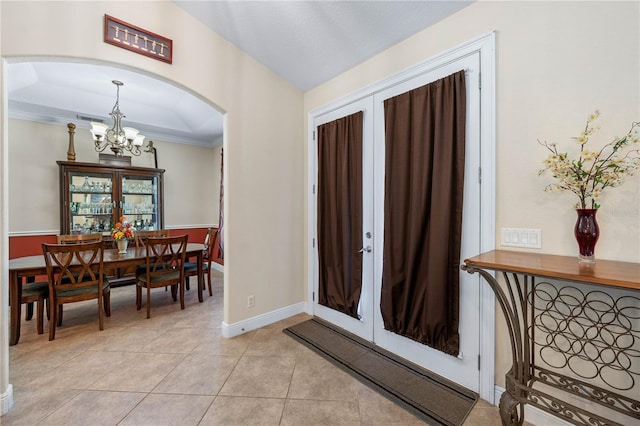 859 Leather Fern Ln, Mims, FL 32754 - entryway featuring arched walkways, a chandelier, light tile patterned floors, ornamental molding, and french doors