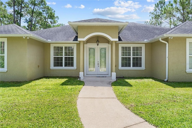 859 Leather Fern Ln, Mims, FL 32754 - entrance to property with stucco siding, roof with shingles, french doors, and a yard