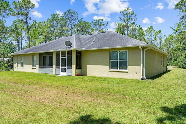 859 Leather Fern Ln, Mims, FL 32754 - rear view of property featuring stucco siding, a yard, a sunroom, and a shingled roof
