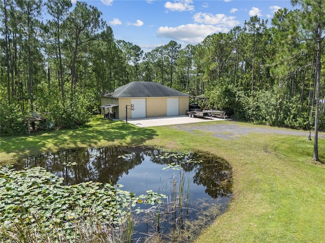 859 Leather Fern Ln, Mims, FL 32754 - view of grassy yard with a detached garage, an outdoor structure, and a water view