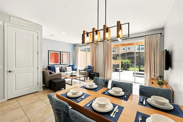 2617 Bugatti Ct, Kissimmee, FL 34746 - tiled dining room featuring baseboards and a chandelier