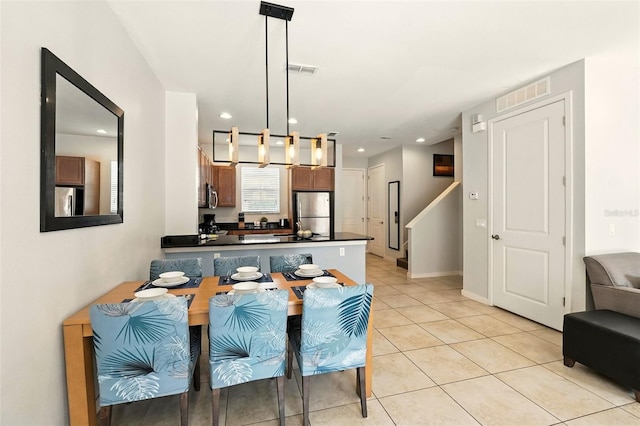 2617 Bugatti Ct, Kissimmee, FL 34746 - dining area featuring light tile patterned flooring, recessed lighting, and stairs