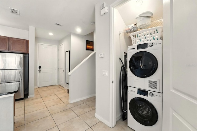 2617 Bugatti Ct, Kissimmee, FL 34746 - laundry room with estacked washer and dryer, light tile patterned floors, and recessed lighting