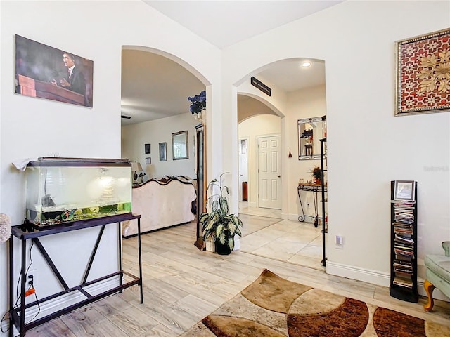 2218 W Gore St, Orlando, FL 32805 - hall with arched walkways and light wood-style floors