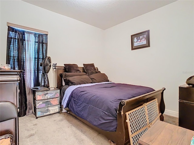 2218 W Gore St, Orlando, FL 32805 - carpeted bedroom with black refrigerator and baseboards
