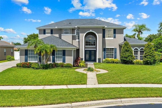 4323 Kezar Ct, Belle Isle, FL 32812 - view of front of house featuring french doors, stucco siding, and a front yard