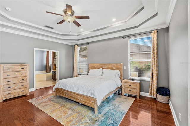 4323 Kezar Ct, Belle Isle, FL 32812 - bedroom with a tray ceiling, ornamental molding, wood finished floors, ensuite bath, and a ceiling fan