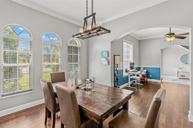 4323 Kezar Ct, Belle Isle, FL 32812 - dining space with arched walkways, hardwood / wood-style flooring, a ceiling fan, crown molding, and a chandelier
