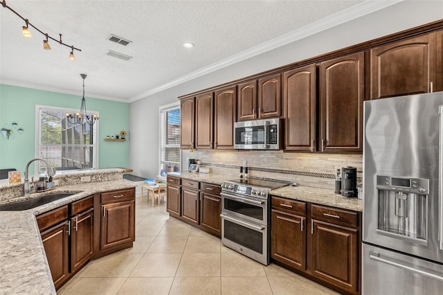 4323 Kezar Ct, Belle Isle, FL 32812 - kitchen with appliances with stainless steel finishes, a textured ceiling, a chandelier, light tile patterned flooring, and dark brown cabinetry