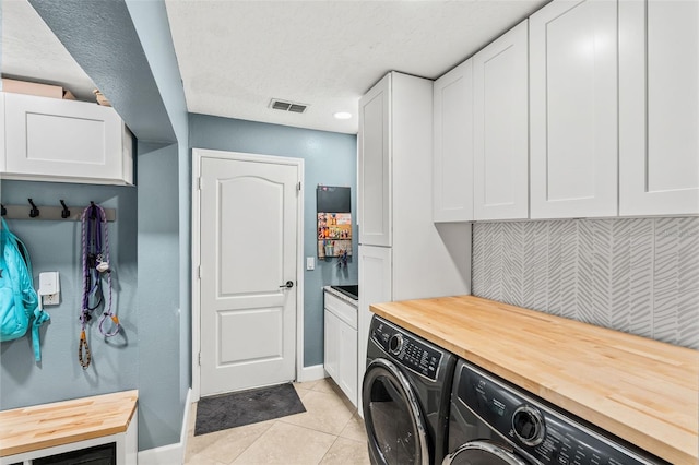 4323 Kezar Ct, Belle Isle, FL 32812 - laundry area with cabinet space, washer and dryer, and light tile patterned floors