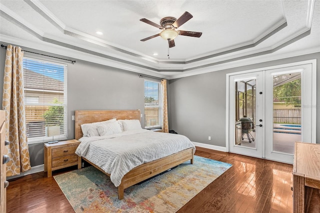 4323 Kezar Ct, Belle Isle, FL 32812 - bedroom featuring a tray ceiling, crown molding, access to outside, hardwood / wood-style floors, and french doors