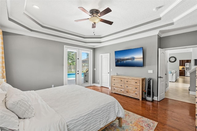 4323 Kezar Ct, Belle Isle, FL 32812 - bedroom with a raised ceiling, access to outside, stainless steel refrigerator with ice dispenser, french doors, and crown molding