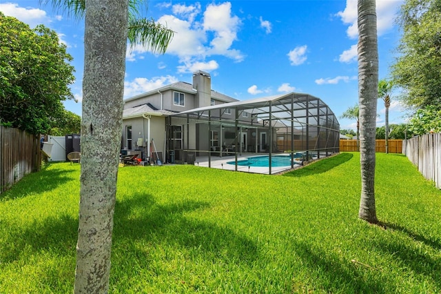 4323 Kezar Ct, Belle Isle, FL 32812 - back of house with a fenced backyard, stucco siding, a chimney, a patio area, and a lanai