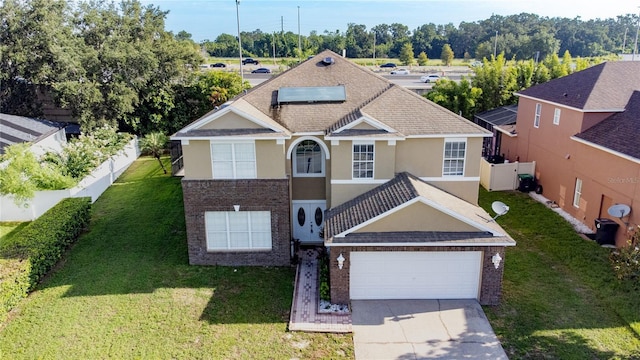 229 Largovista Dr, Oakland, FL 34787 - view of front of property with stucco siding, driveway, roof mounted solar panels, brick siding, and an attached garage